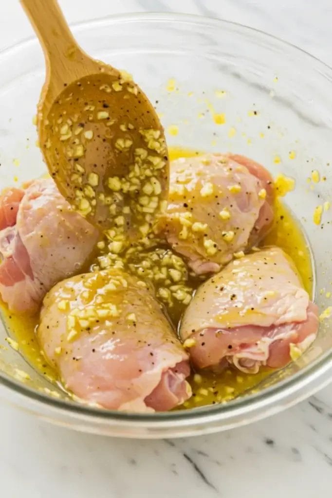 Chicken Thighs Marinating in Lemon Pepper Sauce